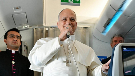 Papst spricht in Mikrofon im Flugzeug