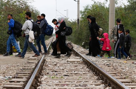 Flüchtlinge in Mazedonien / © 2015 KNA, www.kna-bild.de - Nutzungsrechte vorbehalten., Paul Haring/CNS photo Flüchtlinge überqueren am 19. Oktober 2015 Bahngleise auf dem Weg von dem Transitlager Idomeni durch Mazedonien nach Serbien. Ziel der Flüchtlinge ist der Bahnhof in Belgrad, von dem aus sie mit dem Zug weiterreisen.