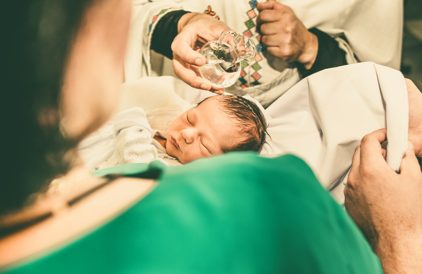 The ceremony of christening the little boy at church