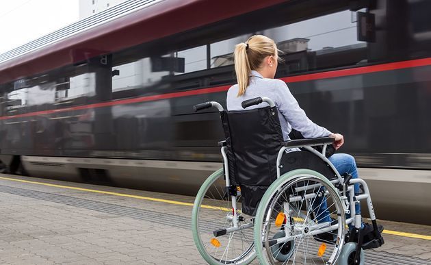 Frau im Rollstuhl vor einfahrendem Zug / bilderbox.com / Wodicka