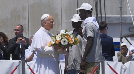 ARGUINEGU?N (GRAN CANARIA), 11/06/2026.- El papa Le?n XIV recibe flores de dos voluntarios para protagonizar una ofrenda floral en el mar en recuerdo de los migrantes muertos en la traves?a durante el encuentro con m?s de un millar de inmigrantes de 